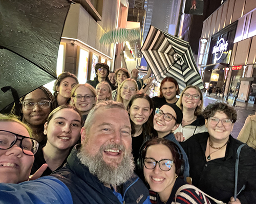 Scott Olinger holds camera for a class selfie in New York.