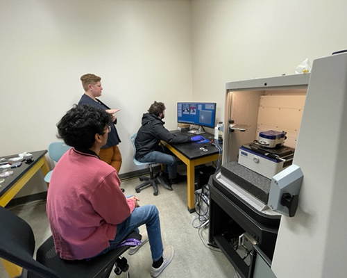 Students work in the lab with Professor Volle.
