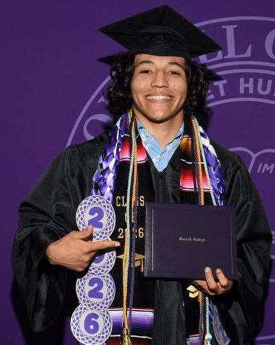 Christian Diaz in his cap and gown at Commencement 2026