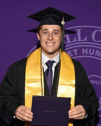 Carson King in his cap and gown at Commencement 2026