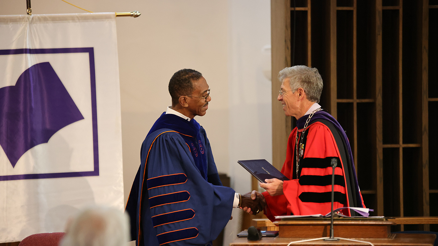 Darrell Wheeler 81 holds the 2026 Distinguished Achievement Award he received during Homecoming Weekend.