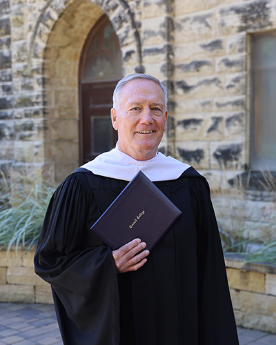 James Swift '76 holds the 2026 Distinguished Achievement Award he received during Homecoming Weekend.