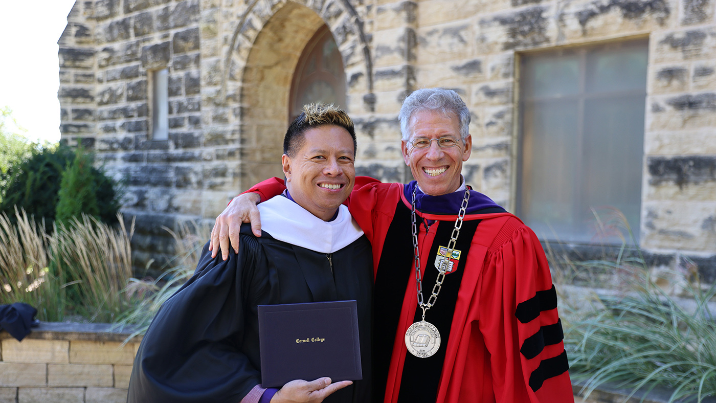 RJ Holmes-Leopold '99 holds the 2026 Leadership and Service Award he received during Homecoming Weekend.
