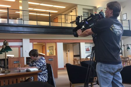 Photographer takes video of student for news story