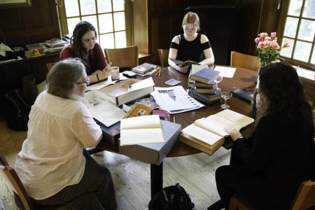 Three students work with Professor Leslie Hankins