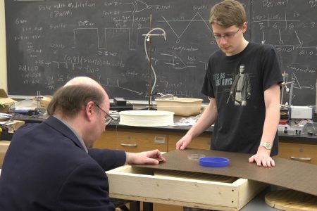 Cropped photo of student, professor creating YouTube videos