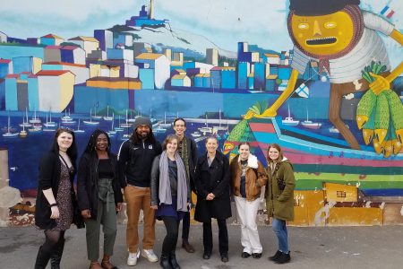 The group in front of a mural in Marseille. The artwork was in the Panier neighborhood of the city, which is the oldest neighborhood in Marseille.