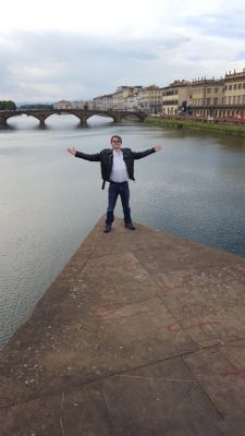 Mackenzie Crow '18 standing near a body of water in Italy