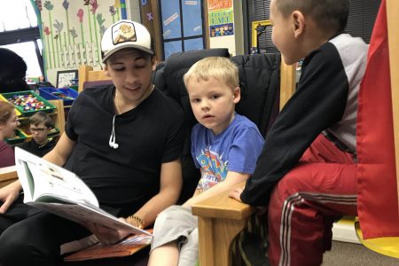 Soccer player Enzo Vanzillotta reads to children