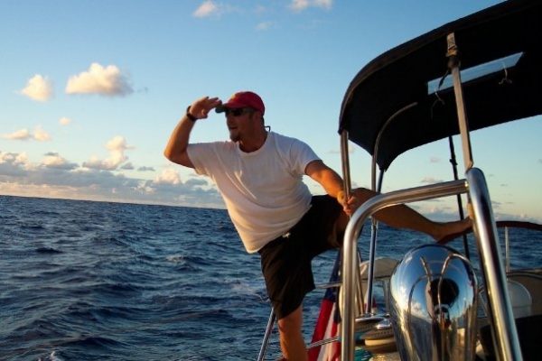 Scott Provinse looking out over the water while standing on a boat