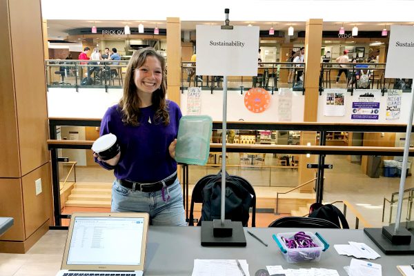 Cali Pfleger '20 holds up the new reusable to-go containers