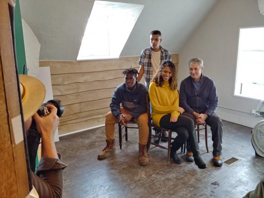 Photo of photographer taking picture of people involved in the documentary