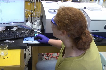 Samantha Slaymaker looks at a computer screen during her summer research at Cornell Colllege