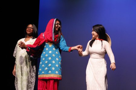 Three students perform on stage for the Culture Show at Cornell College