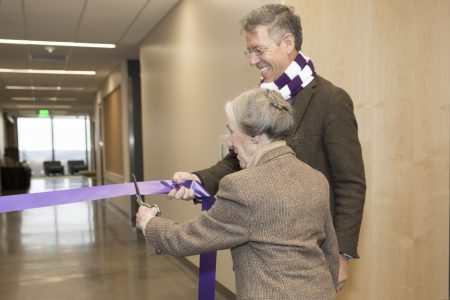 Jean Russell cuts the ribbon as President Jonathan Brand holds the end