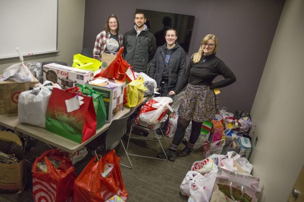 Smiling photo of group who organized the Angel Tree efforts and delivering the packages.