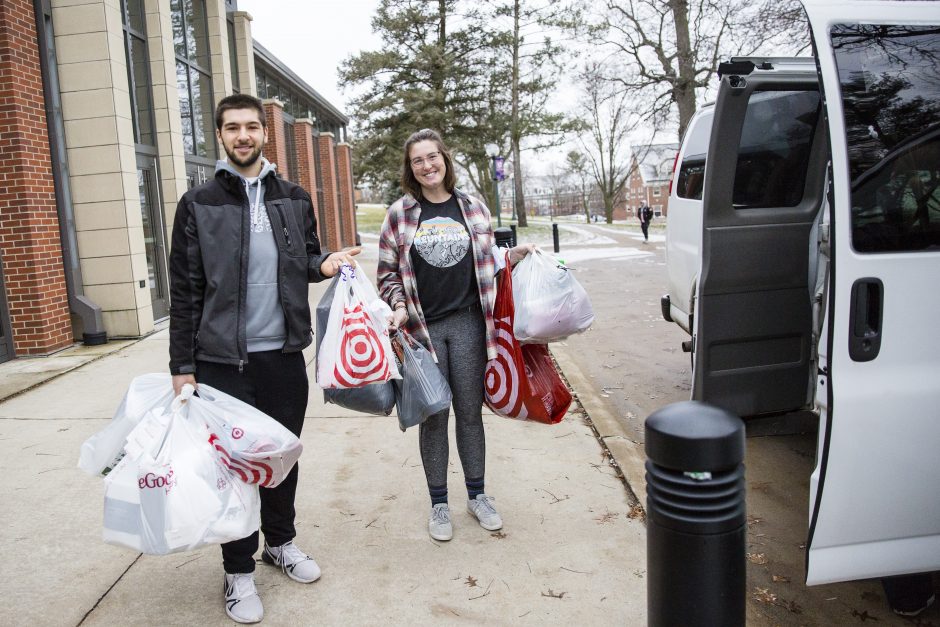 Students gather packages to put in a van.