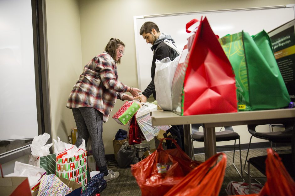 Students gather packages to put in a van.