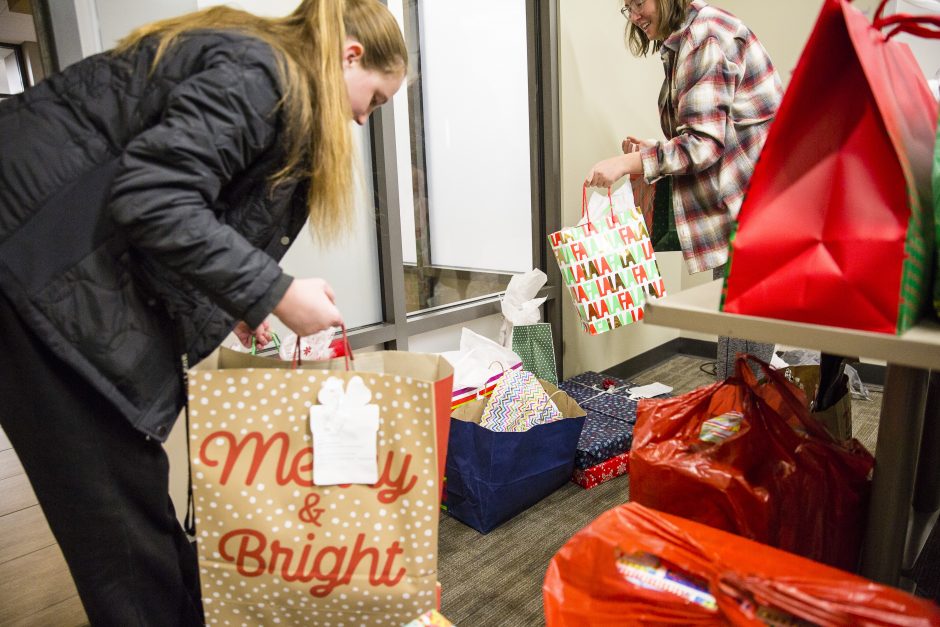 Students gather packages to put in a van.