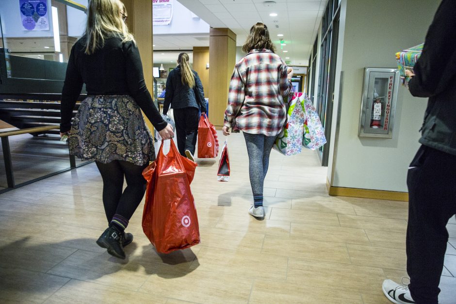 Students gather packages to put in a van.