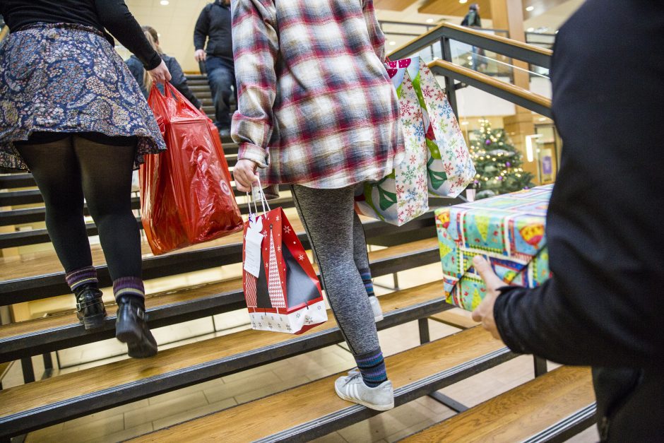 Students walking up the steps in the Thomas Commons as they load up gifts for families in the area.