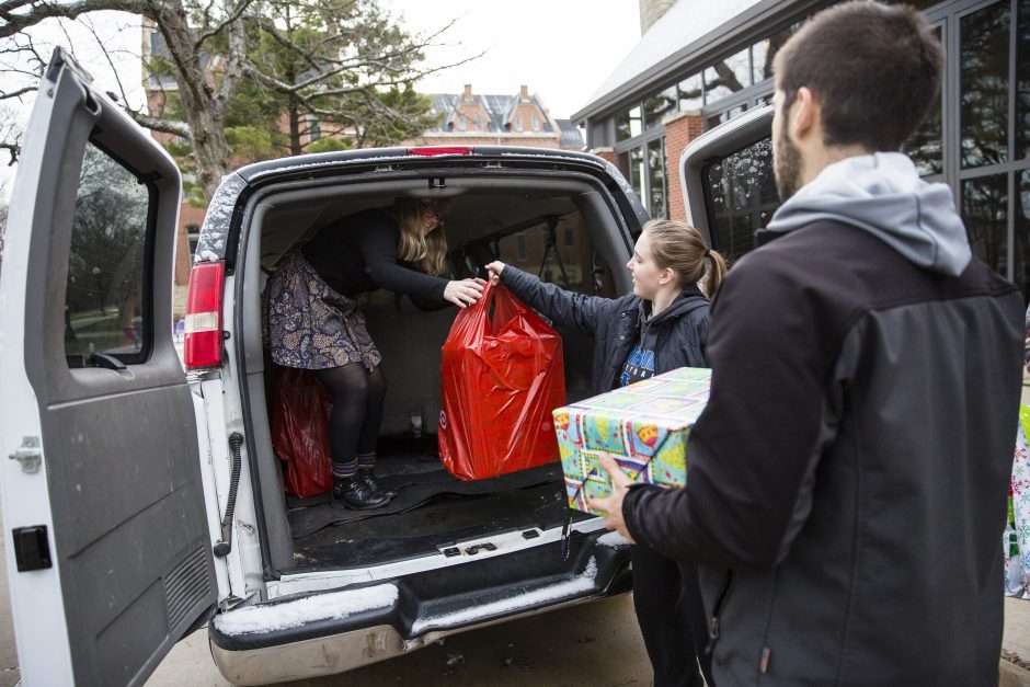 Students load packages into a van.