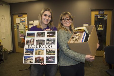 Lexi Woywod ’21 (left) and Hannah Ganzel holding books