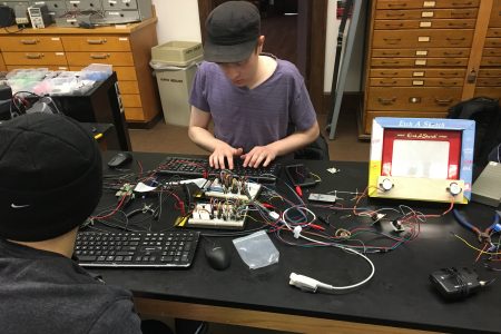 Nick Duesing ’20 works to create a computer-controlled Etch A Sketch in his engineering class