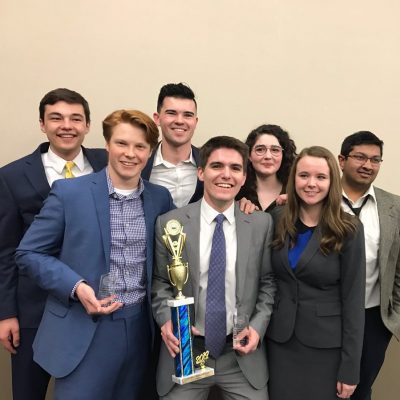 Cornell College Mock Trial Team holds a trophy and smiles for a photo