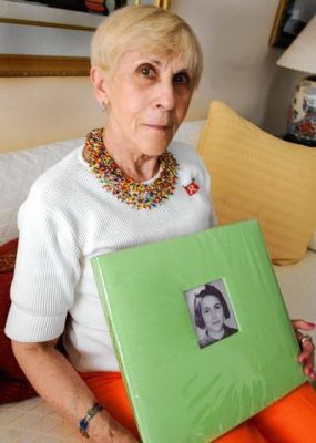 Rachel Goldman Miller holding a photo of a young child