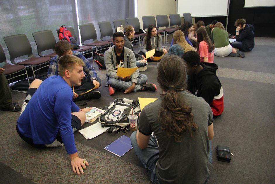 Cornell students work in groups with high school students