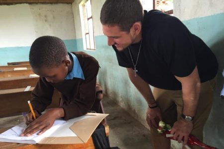 Futrell with a child during the Economic Development in Rural Tanzania class in 2016