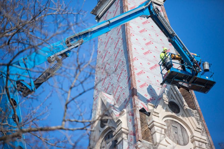 While the college’s 1882 Seth Thomas clock is being restored in New York, crews have been repairing and preserving its home, the King Chapel clock tower. The project includes replacing rafters, framing, joists, masonry, and shingles. Photo by Allan Recalde. 