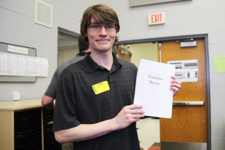 Tray Guess holding a piece of his sheet music.