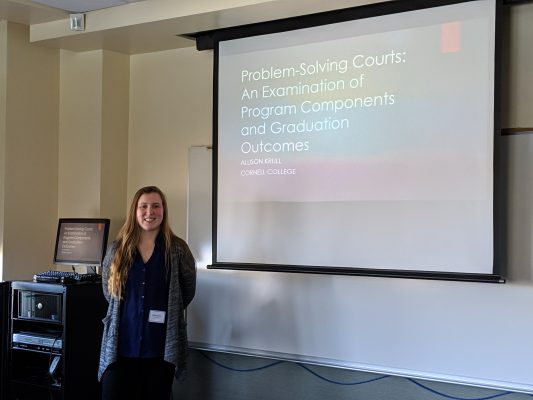 Allison Krull standing by her presentation