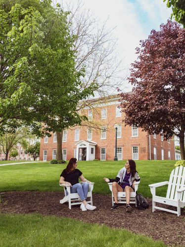 Students in adirondack chairs