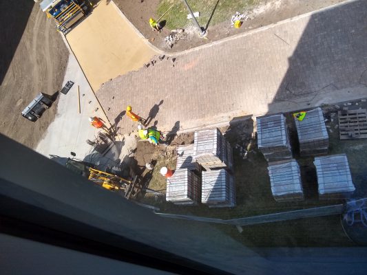 construction crews installing pavers on the new ped mall walking path