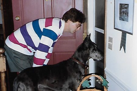 Tim Wynes and his dog Hayley hand out treats to trick-or-treaters.