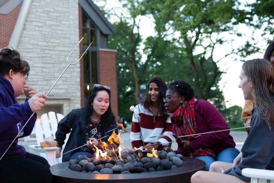 Students roasting s'mores at the fire pit