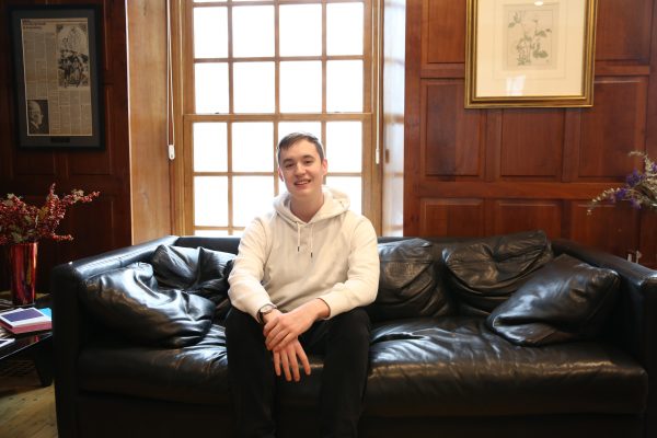 Sophomore Connor Kenney sits in Van Etten-Lacey House, home to Cornell's Center for the Literary Arts.