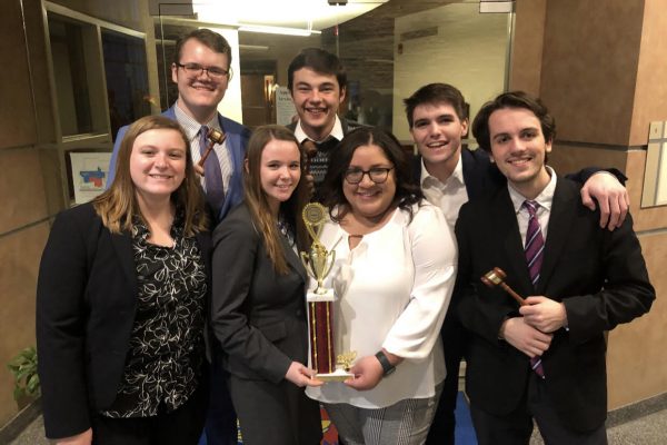 Students holding trophy