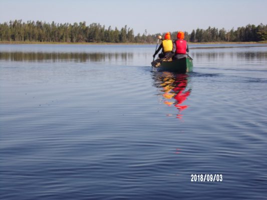 Natalie Bradshaw photo taken on the lake of two students in a canoe.