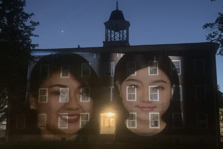 image of faces projected on building