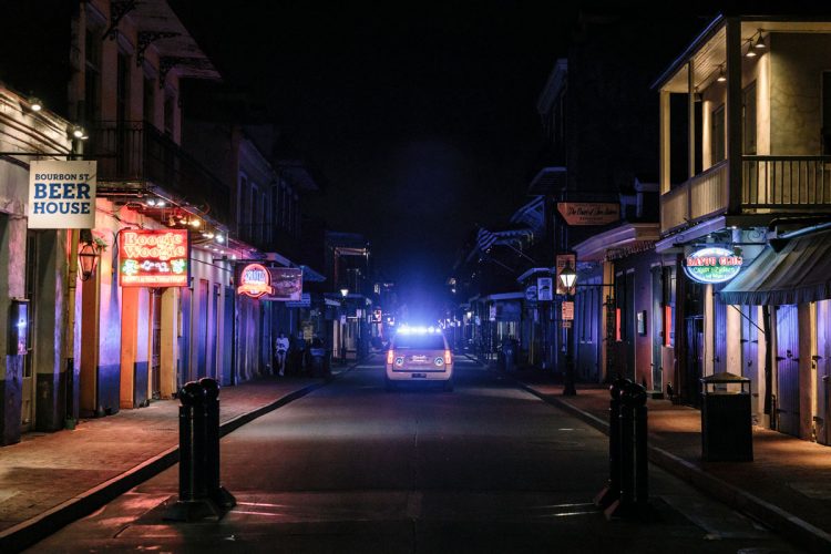 Will Widmer ’04 photographed a mostly deserted Bourbon Street in downtown New Orleans on March 18 for the New York Times. Local and state law enforcement vehicles patrol the area using loudspeakers to encourage locals to go home, and tourists to return to their hotels.
