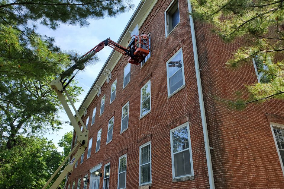 Workers putting in windows in College Hall