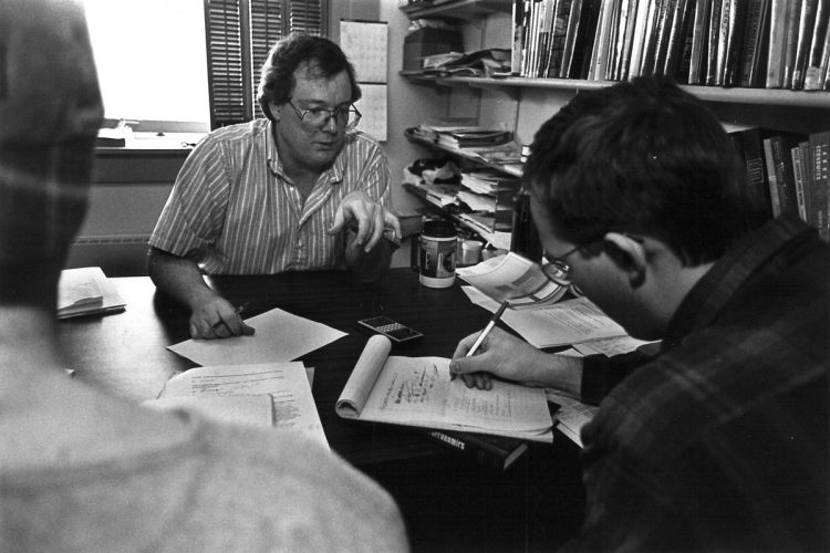 Jerry Savitsky works with students in his College Hall office in 1997.