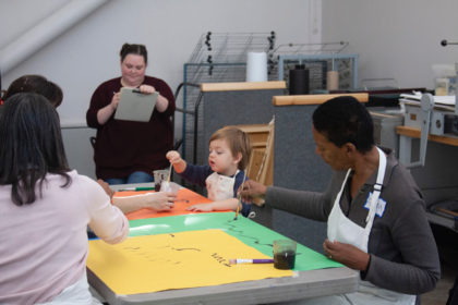 Olivia Lohmann takes notes during an intergenerational art program at the Frye Museum of Art. 