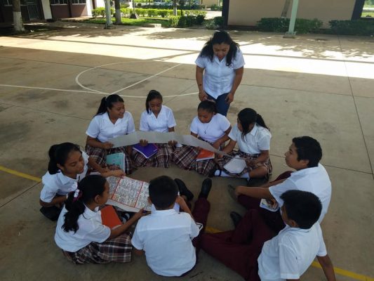 Middle students hold a copy of the Dresden Codex in the Maya town of Calotmul, Yucatan, Mexico. 