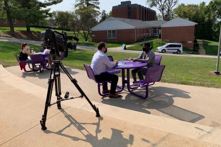 TV reporter interviewing student