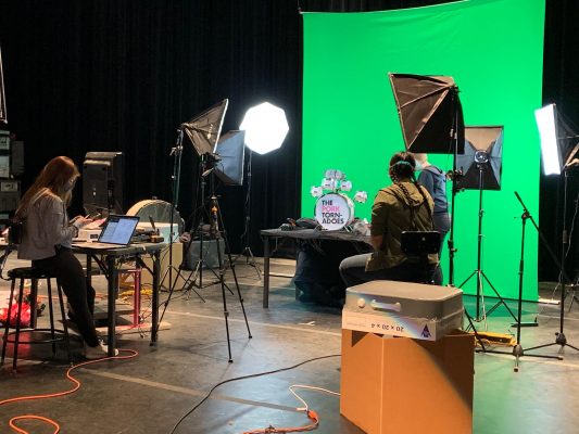 Maggie McClellan (left), Camille Wong, and Regen Kuker preparing for a puppet video shoot.